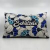 Coussin Schàtzele, tissu à motifs.