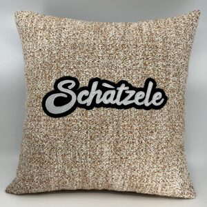 Coussin Schàtzele, toile blanche et orange.