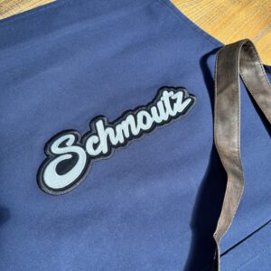 Tablier Schmoutz,
Toile bleue.